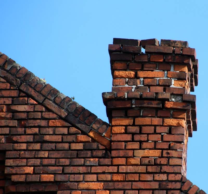Damaged chimney on an Newton home showing cracks and missing mortar